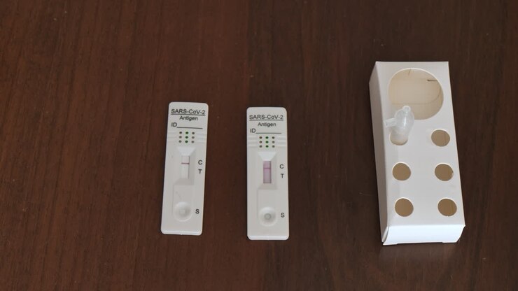 Rapid swab test lateral flow antigen for sars covid corona virus infection, isolated on wooden desktop background
