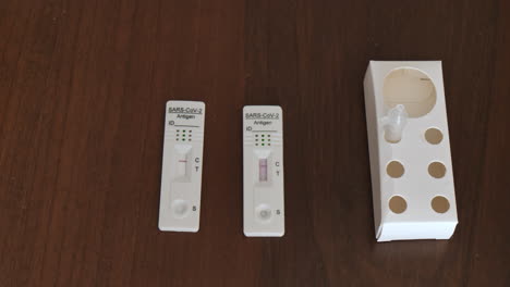 rapid swab test lateral flow antigen for sars covid corona virus infection, isolated on wooden desktop background