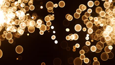 abstrakte glühende gold-bokeh-bubbelpartikel, die auf schwarzem hintergrund fliegen. orange-rot-gold-bukeh-partikel und staub fliegen in der luft auf einer super-slow-motion-kamera mit 1000 fps.