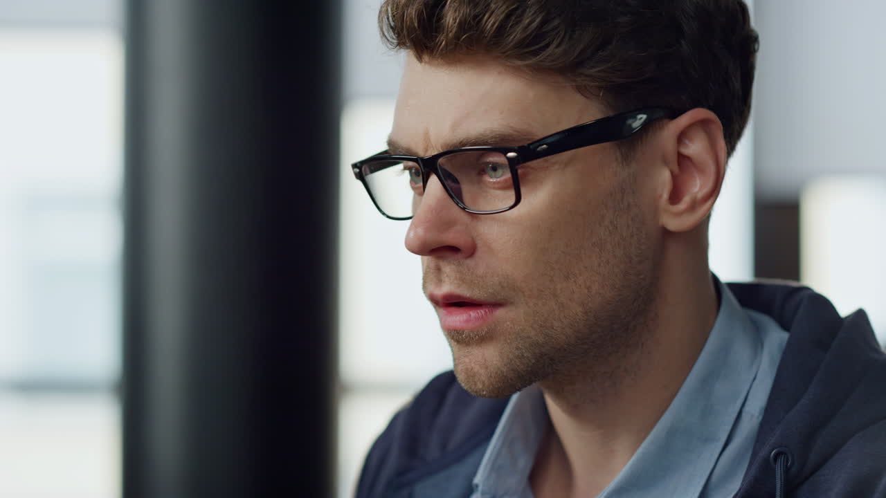 Focused it guy checking online report closeup. Pensive businessman in glasses