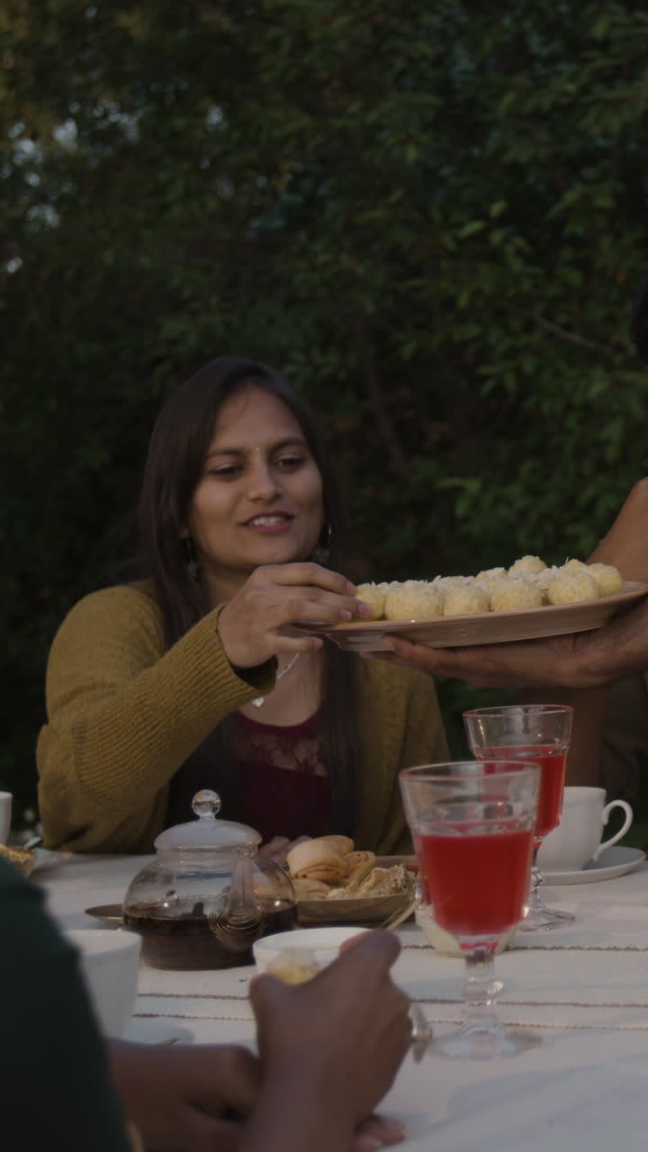 People enjoying dessert at an outdoor gathering