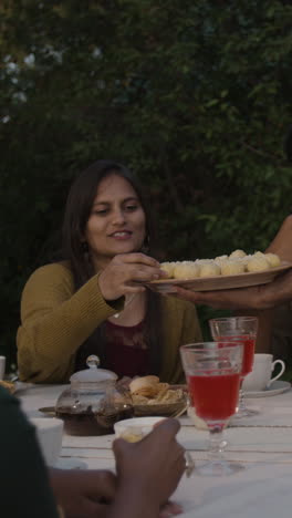 people enjoying dessert at an outdoor gathering