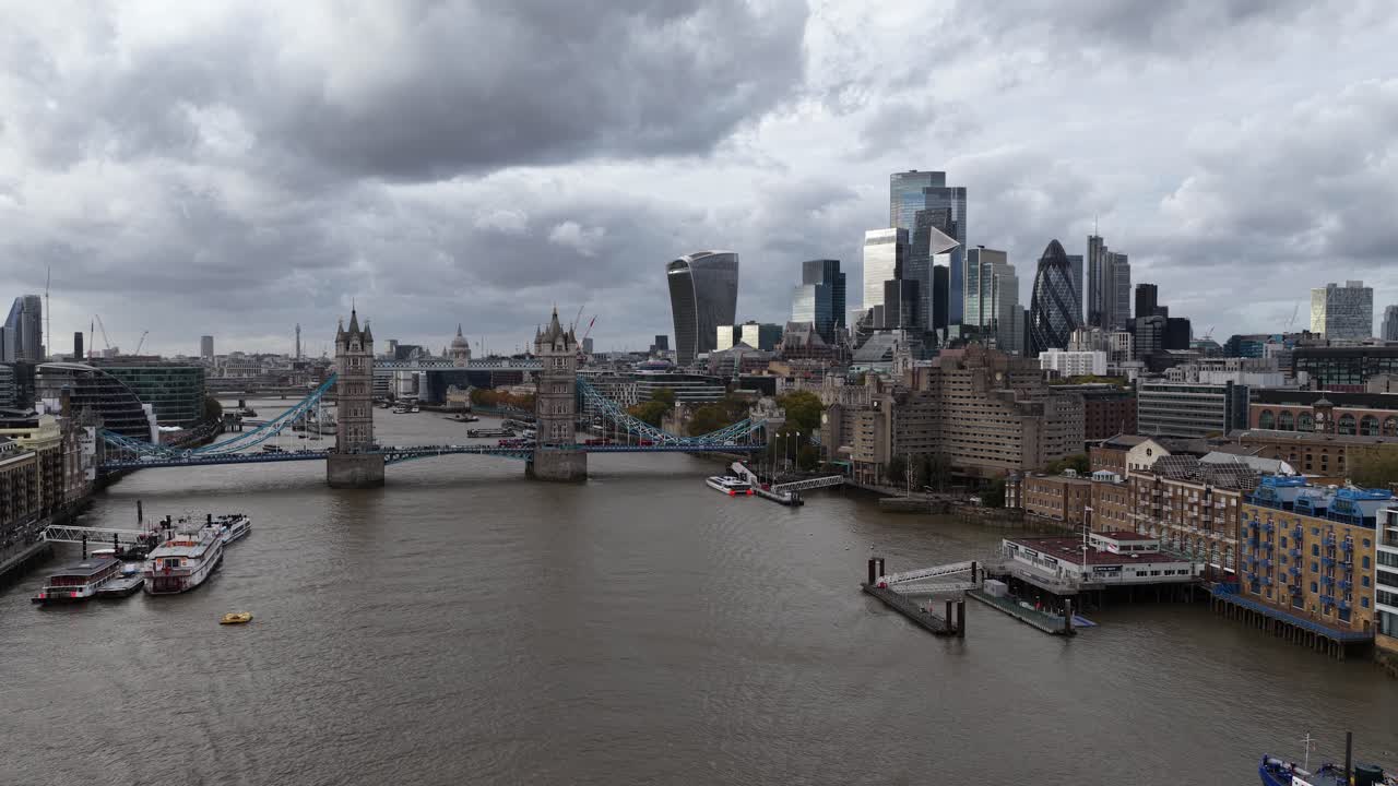 Skyline of London, tower bridge, and financial center with skyscrappers. Aerial drone video over thames river