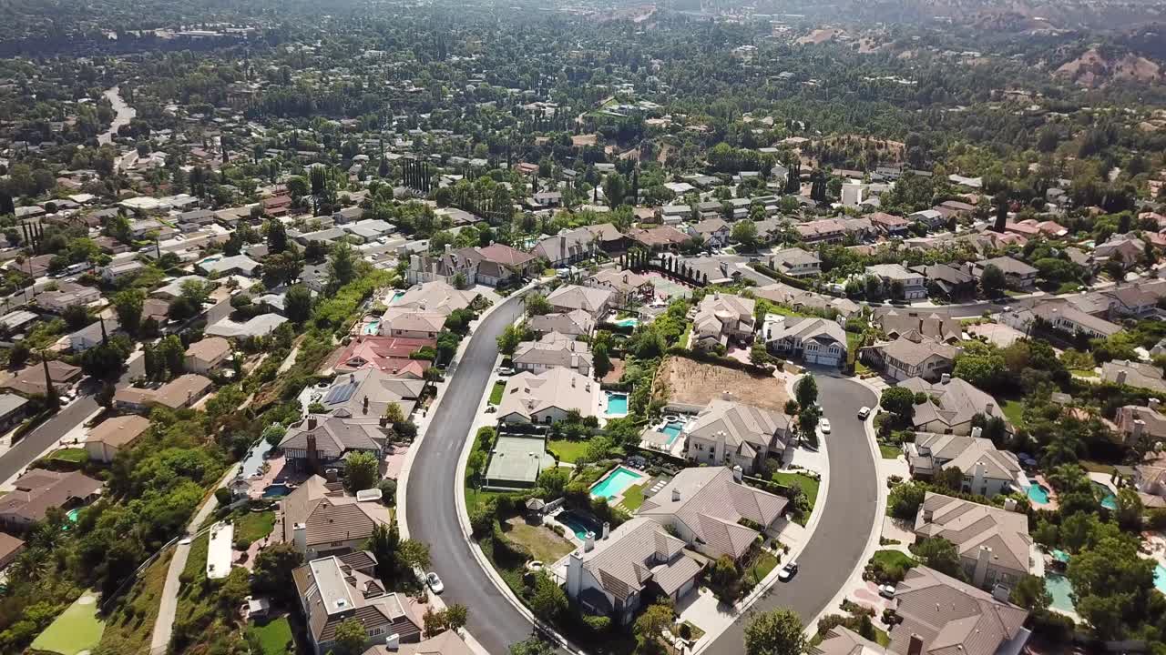 Expensive real estate villas with pool and tennis field on top of Mountain. Sunny day in Hidden Hills. Neighborhood of famous Celebrities in America. Aerial birds eye shot.