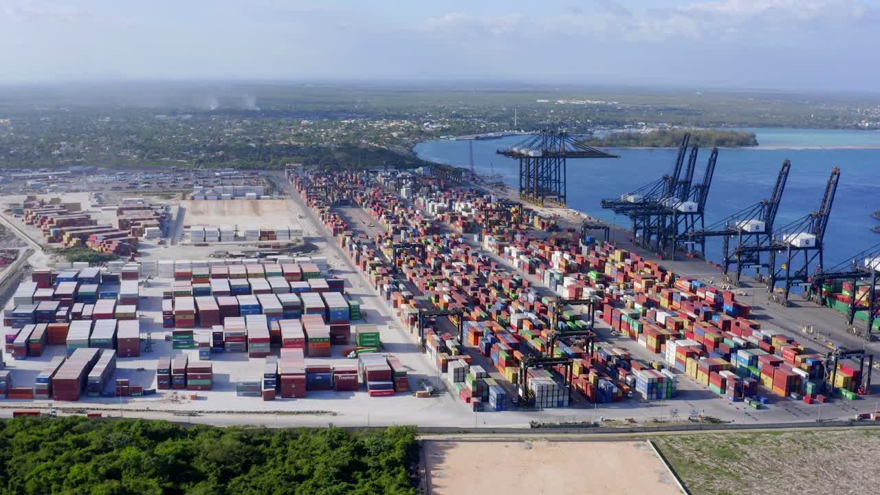 Flying over huge port of Caucedo cargo terminal. Sky for copy space