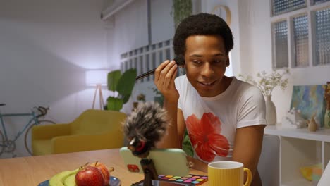 person applying makeup while recording a video
