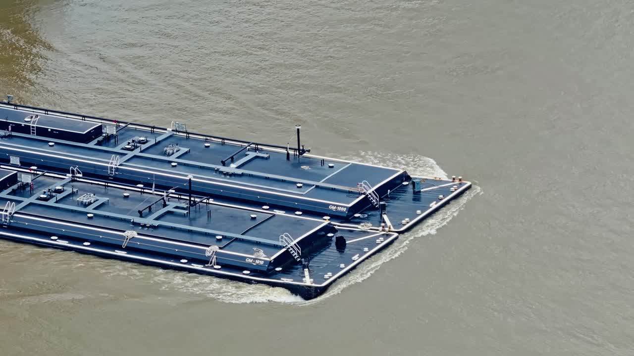 Flat-bottomed Barge Pushed By Towboat In Mississippi River In New Orleans, USA. - wide shot