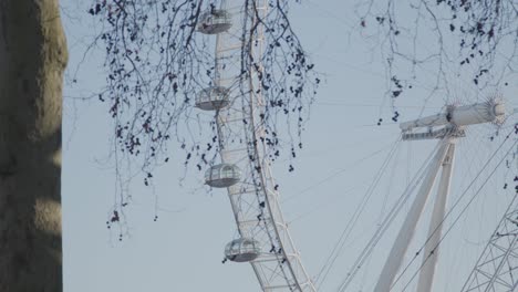 the london eye with a crane moving in the foreground.