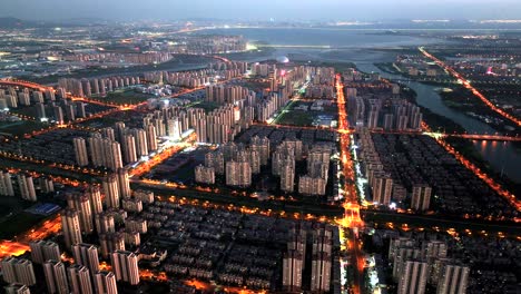 in the evening, city buildings light up and roads are illuminated by the lights