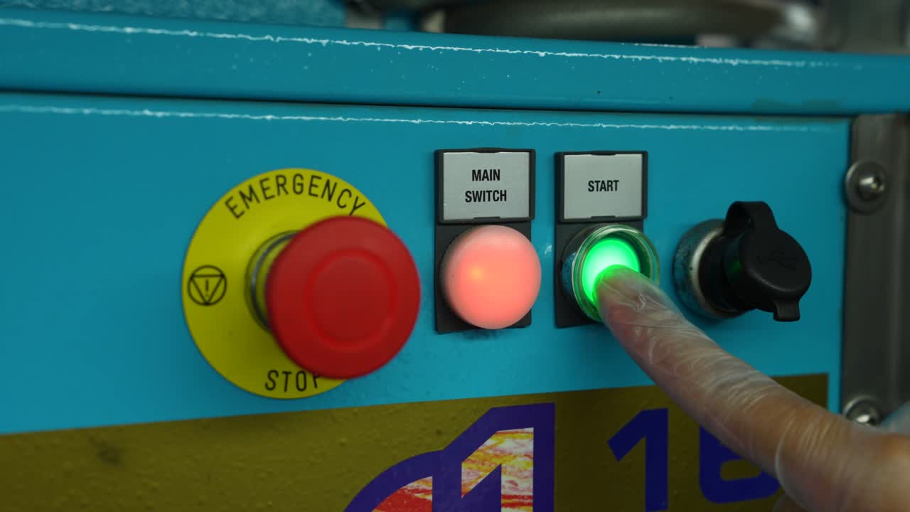 Scientist Lab Technician Pressing Start Button On A Machine During Testing Textiles For Chemical Analysis