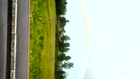pov looking out car window driving past green grass landscape in sweden