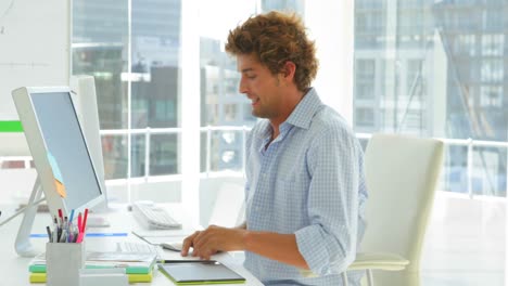 Amused-young-businessman-sitting-playfully-down-