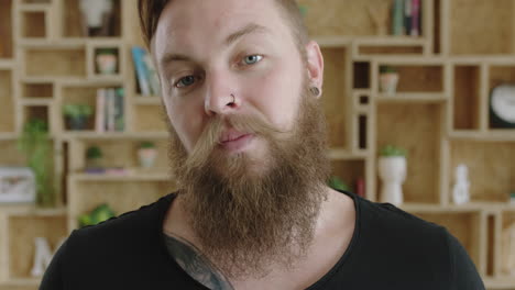 close-up-portrait-of-handsome-young-hipster-man-with-beard-looking-serious-pensive-at-camera