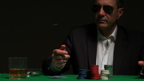 cool gambler flipping a chip