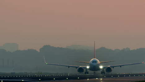 airplane landing at sunset