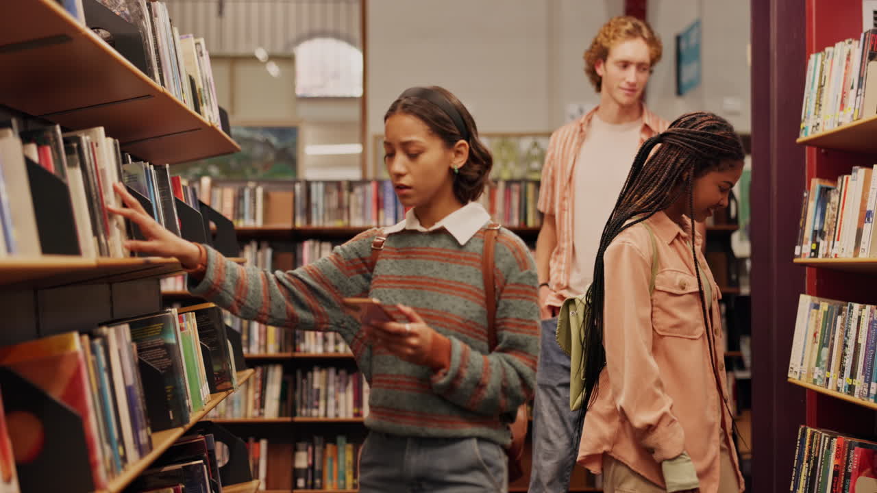 Students browsing books in a library