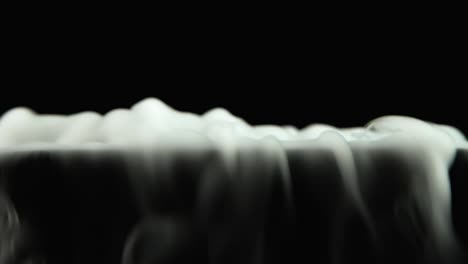 closeup of dry ice is pouring out closeup on black background - closeup of dry ice is pouring out closeup on black background at dark studio