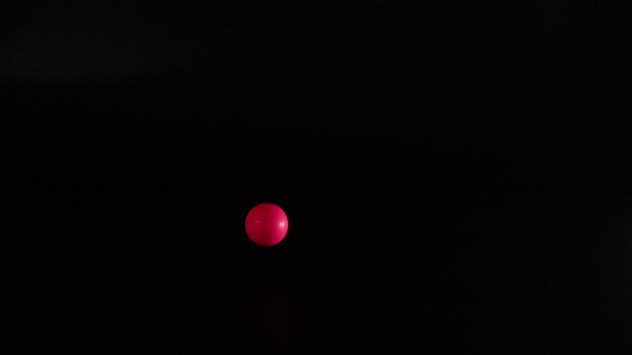 Red ball bouncing in dark environment