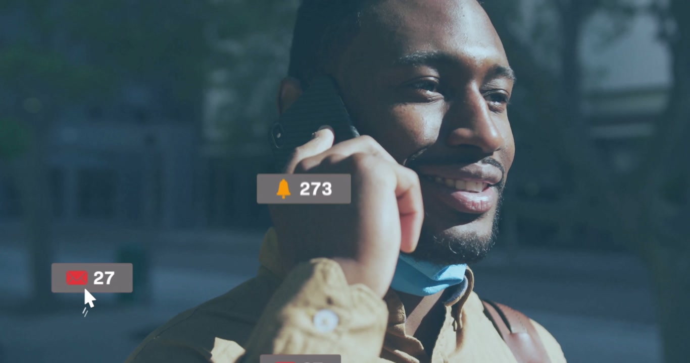 Man holding smartphone to ear on city sidewalk, generating animated social media icons around him