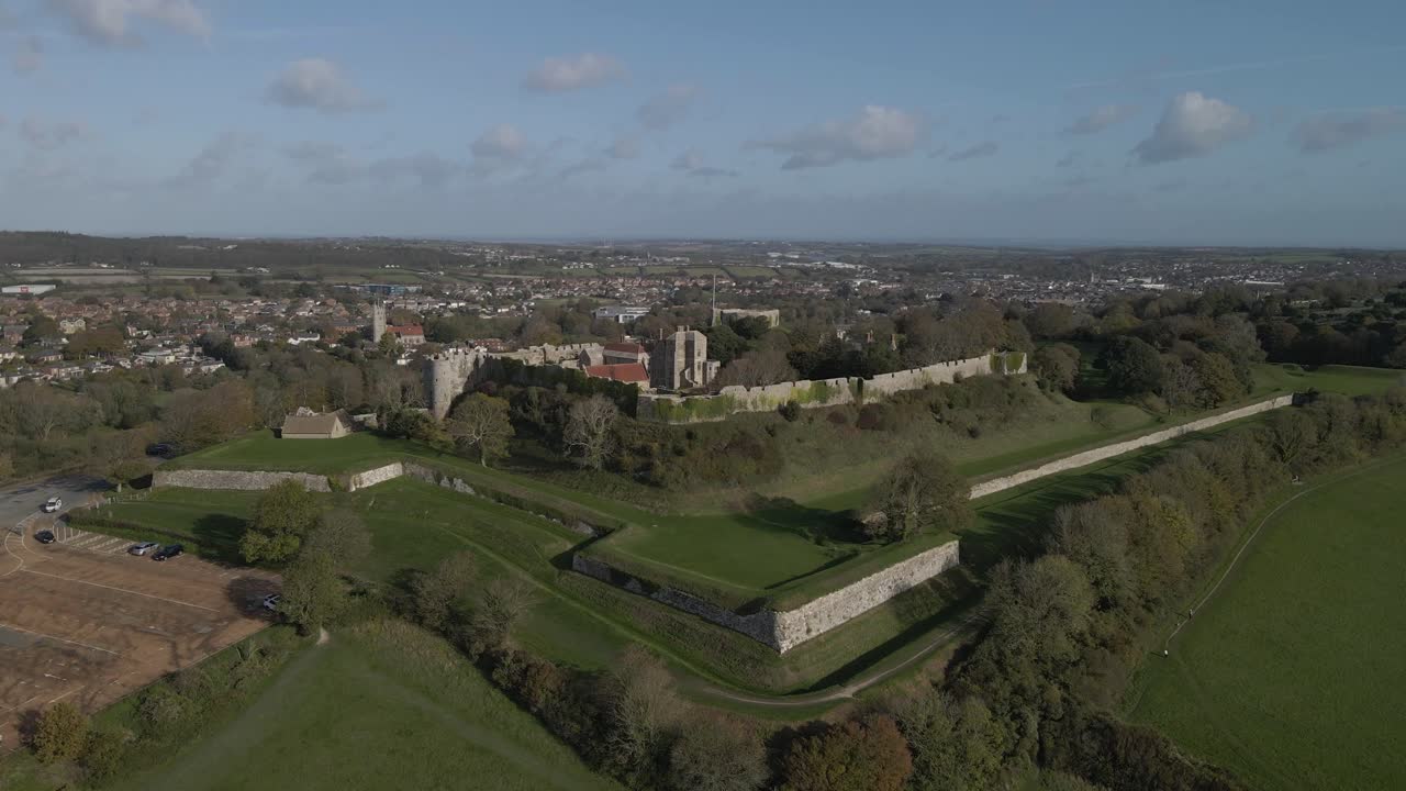 Castle a great fortress which began life as an Anglo-Saxon earthwork defence against Viking raids. Drone rotating to the right over the castle, the buildings and the green fields around the castle