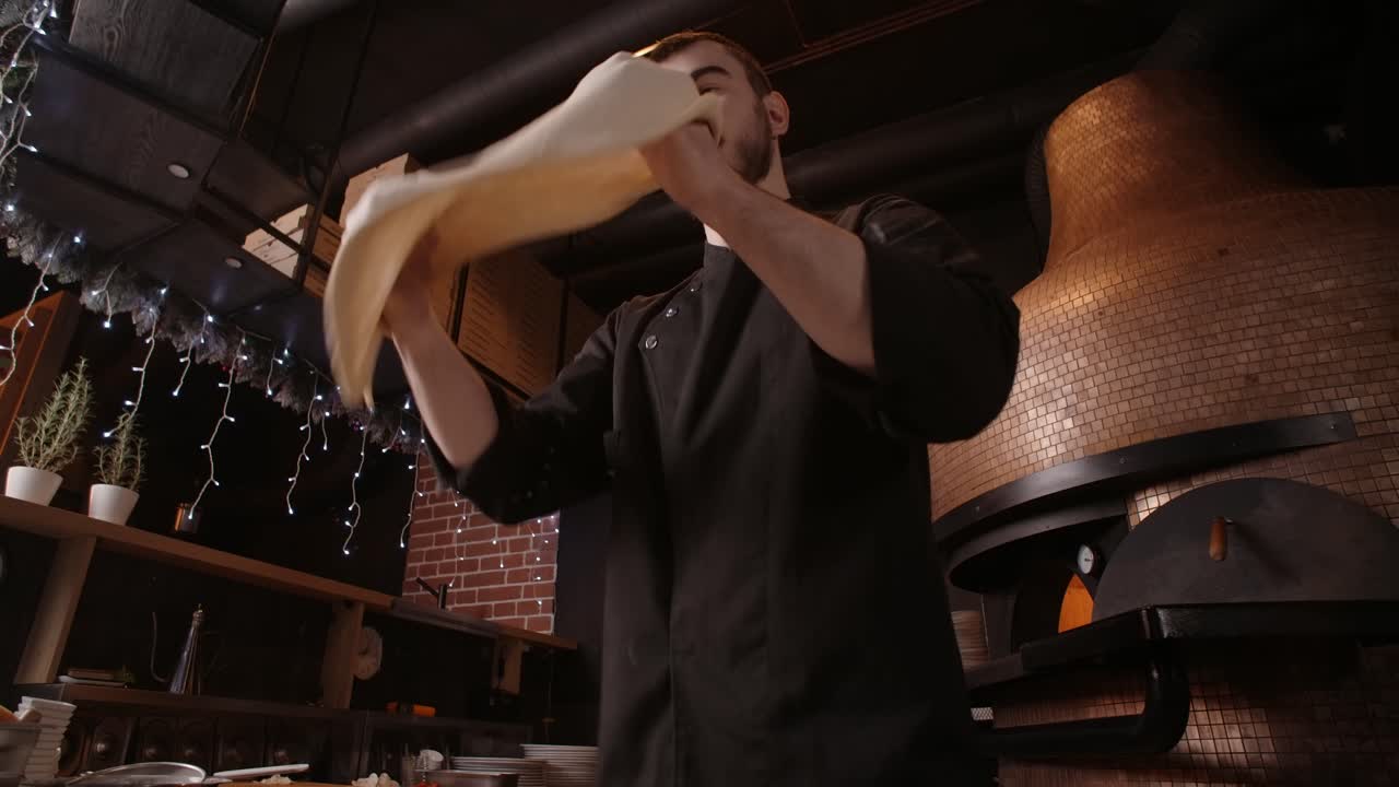 Pizzaiolo Preparing Pizza in a Wood-Fired Oven