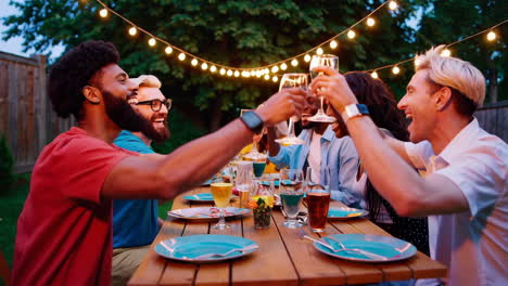 friends toasting and celebrating at an outdoor dinner party