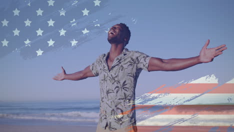 animation of american flag over african american man raising hands at beach