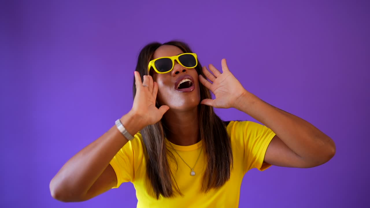 Woman with yellow sunglasses shouting