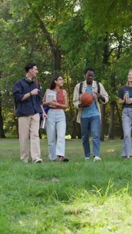 group of students walking and talking in a park