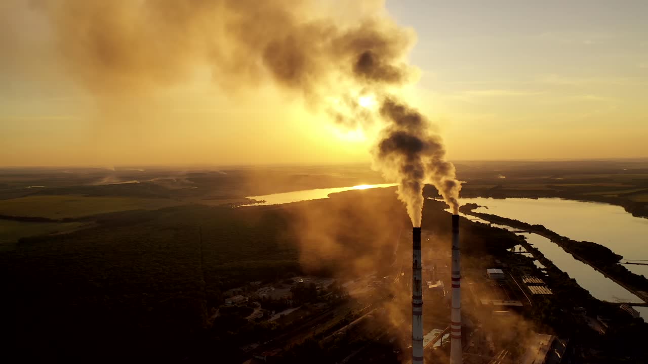 Fuming pipe power plant. Industrial landscape of manufacturing factory buildings with smoke pipes