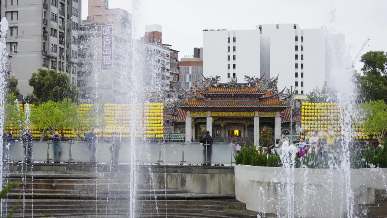 Exterior of Lungshan Temple Viewed from Bangka Park with Rising Water Fountains in the Foreground, Taipei City, Taiwan