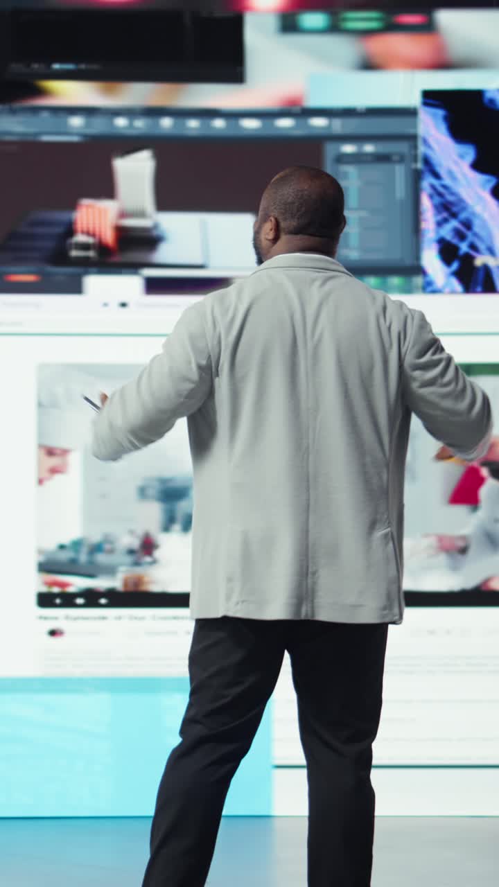 Vertical video Smiling man using phone gains access to thousands of videos with press of button