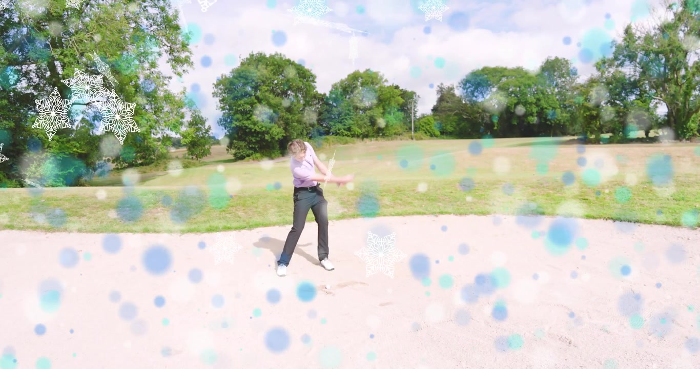 Male golfer entering sand bunker for golf training, swinging club and lifting ball toward green