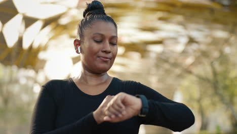 woman checking activity tracker while exercising