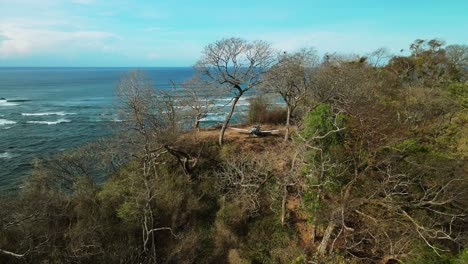 abandoned small airplane stuck on the top of a hill by the coast in costa rica, province of guanacaste 4k aerial drone circling close