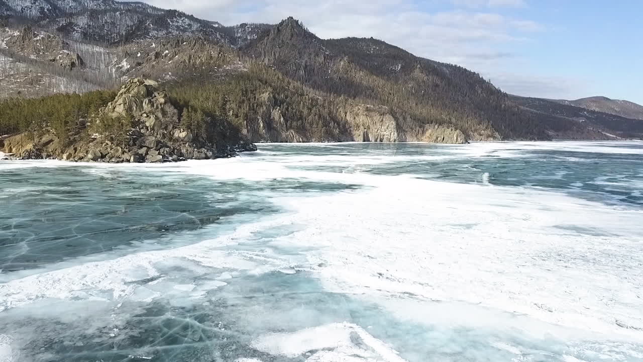 Frozen Lake Baikal with Mountains in the Background