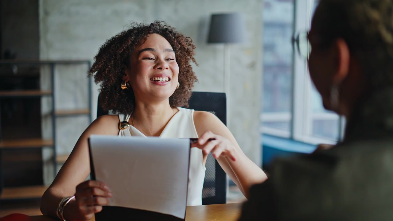 Cheerful female professional laughing explaining contract client meeting talk.