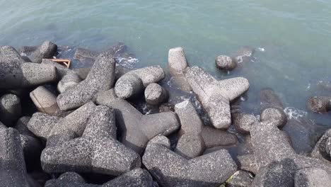 seashore waves striking black rocks at queens necklace marine drive beach mumbai, india marine drive water waves, panoramic view, mumbai, india