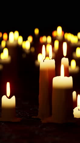 group of lit candles on table