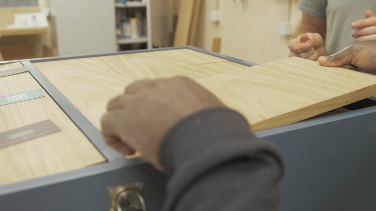 Carpenters working together making bespoke wooden press