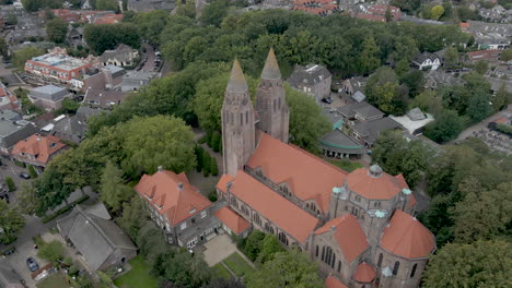 Slow-jib-down-angle-of-large-church-in-small-town