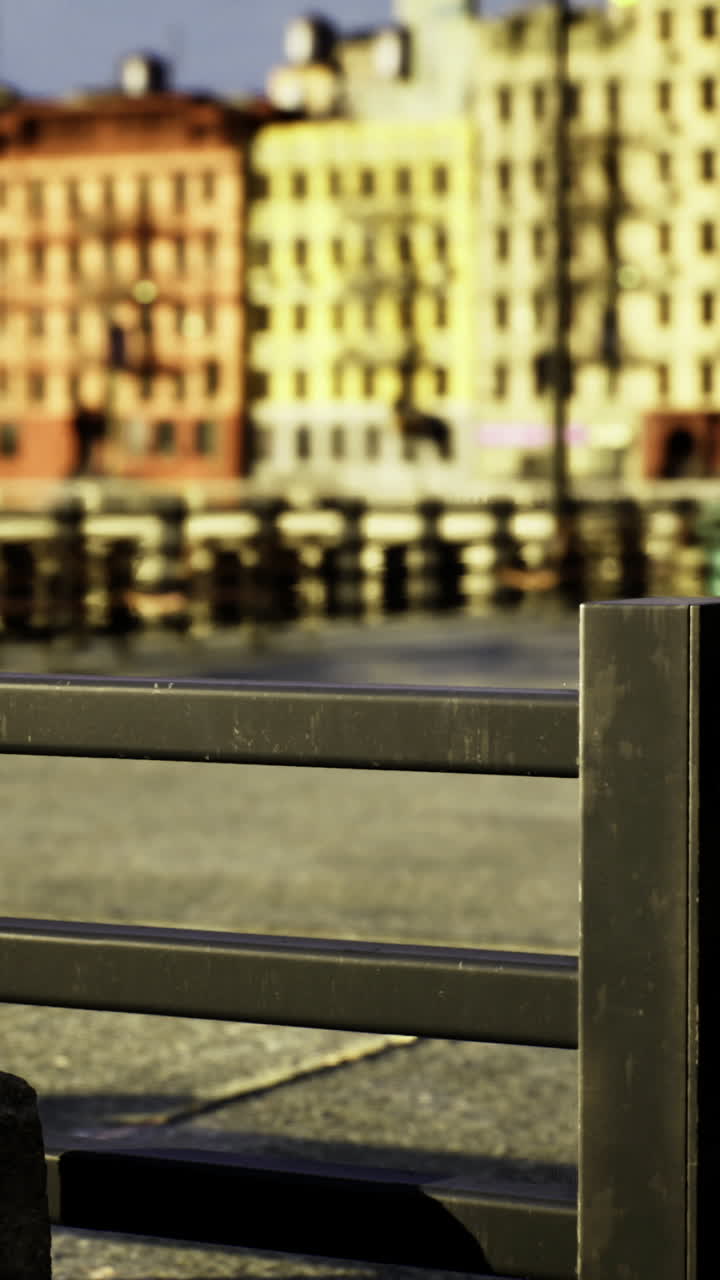 Urban waterfront view with colorful buildings under clear sky
