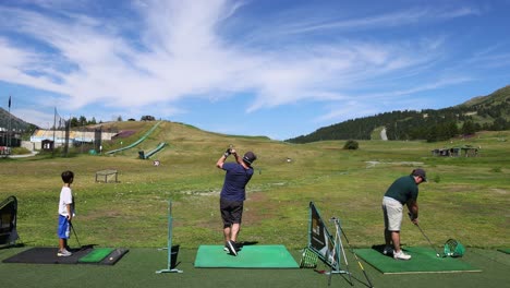 two people practicing golf in a scenic location