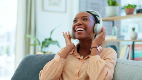 Black-woman,-headphones-or-dancing-on-house-sofa