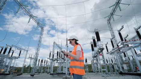 an engineering employee makes a tour and inspection of a modern electrical substation. energy.