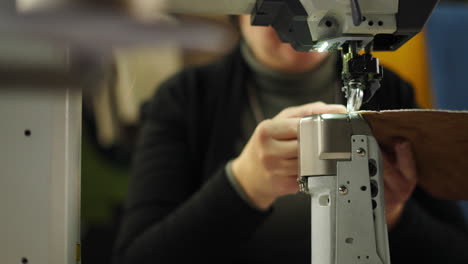 woman operating a sewing machine working with leather