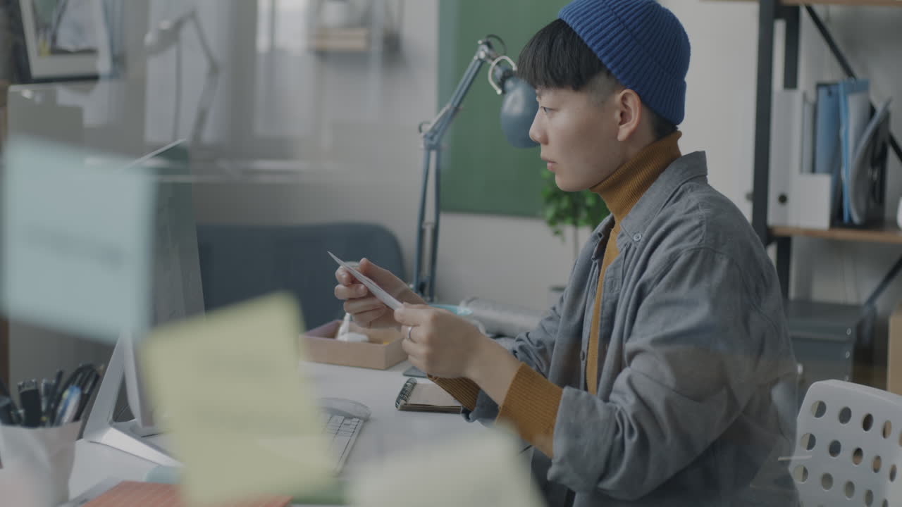 Young Woman Reading Documents in a Modern Office