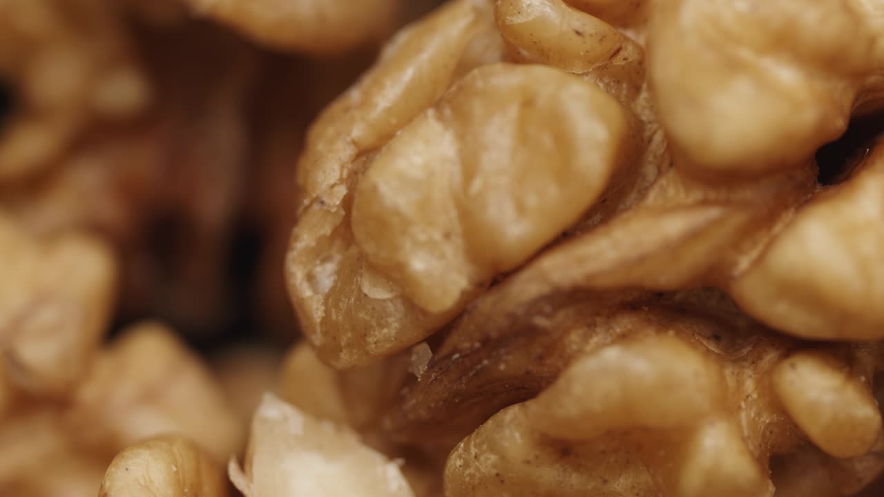 Smooth Camera Movement Over a Handful Walnuts.