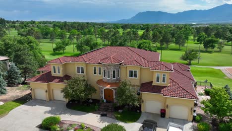 beautiful mansion on golf course with view of mountains