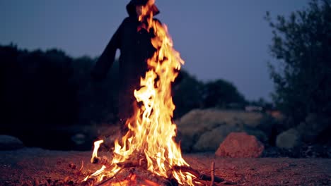 the old witch cooks a sorcery potion in the thicket of the forest. fairy tales on halloween. burning fire.